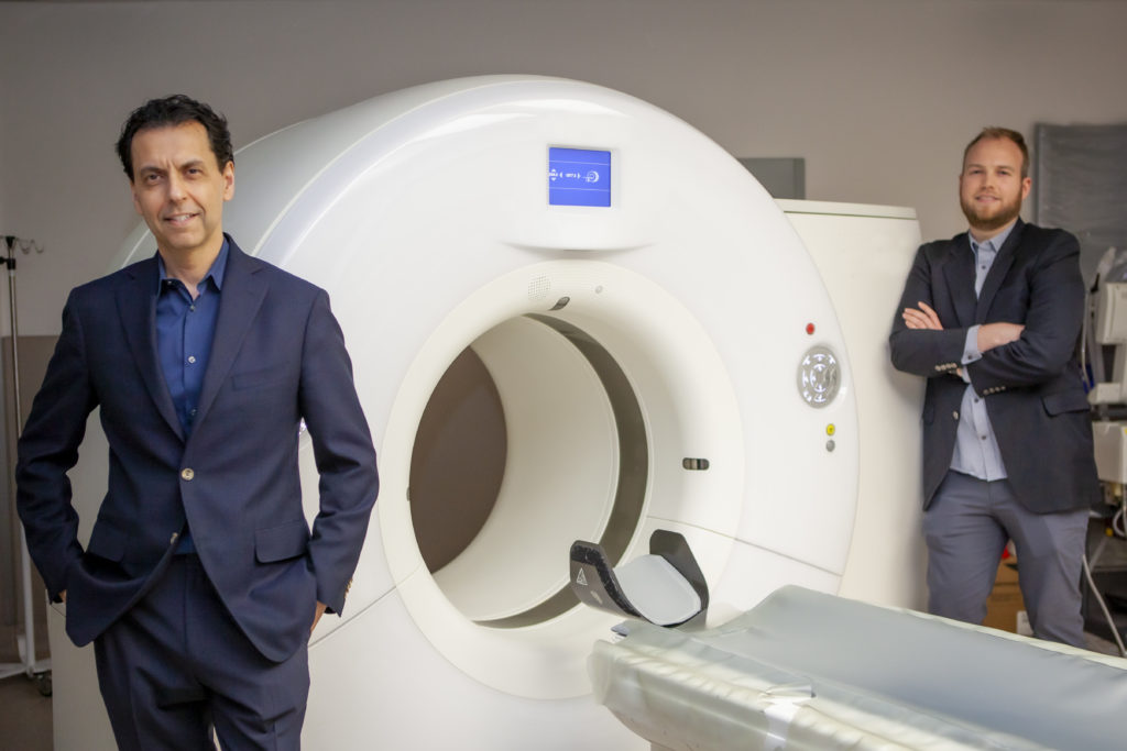 Dr. Savvas Nicolaou and Dr. William Parker with a CT scanner.